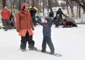 This young one is very excited to learn how to snowboard! 