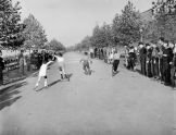 Boys compete in a rollerskating race on Riverside Drive 